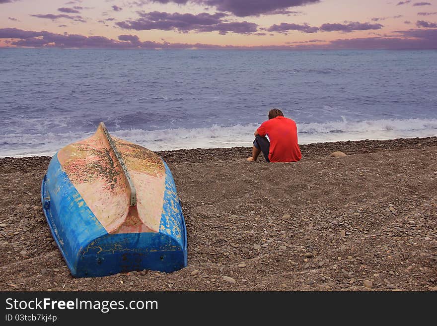 A men and a boat near the sea. A men and a boat near the sea