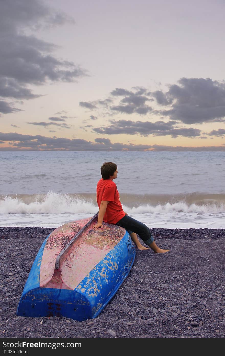 A man and a boat near the sea. A man and a boat near the sea