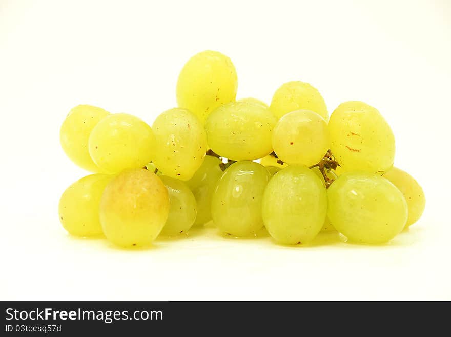 Image of a cluster of green grapes on white fund. Image of a cluster of green grapes on white fund.