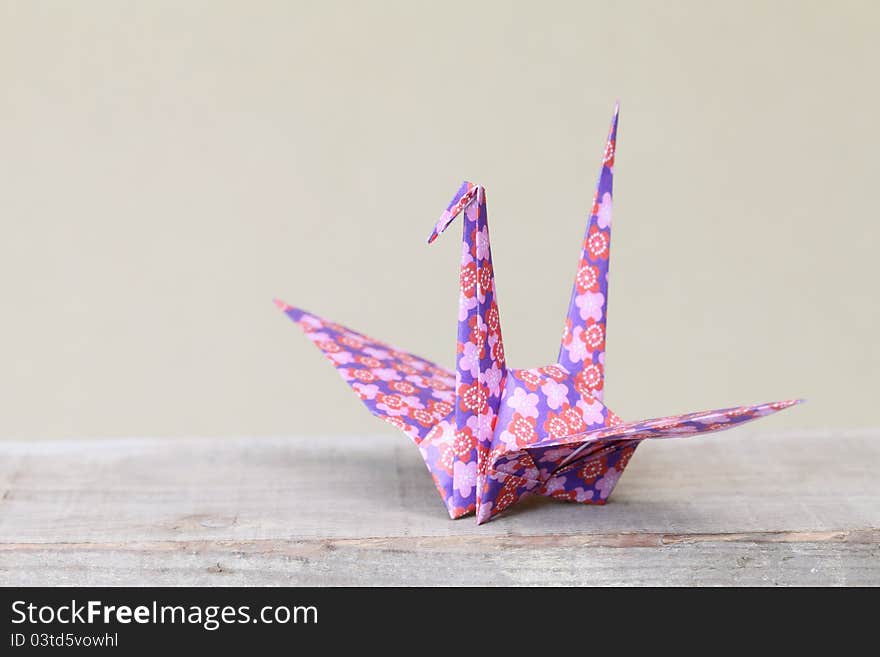 Close up of origami bird on a shelf