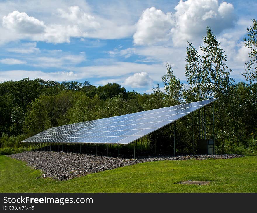 Industrial solar panel nestled in country greenery. Industrial solar panel nestled in country greenery.