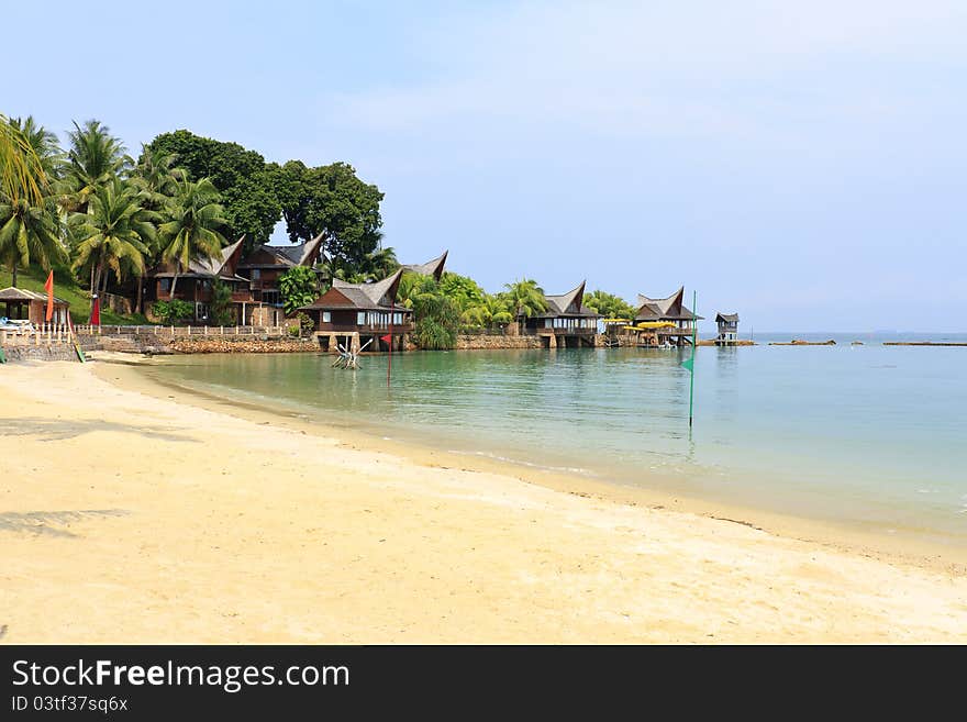 Tropical beach and palm huts