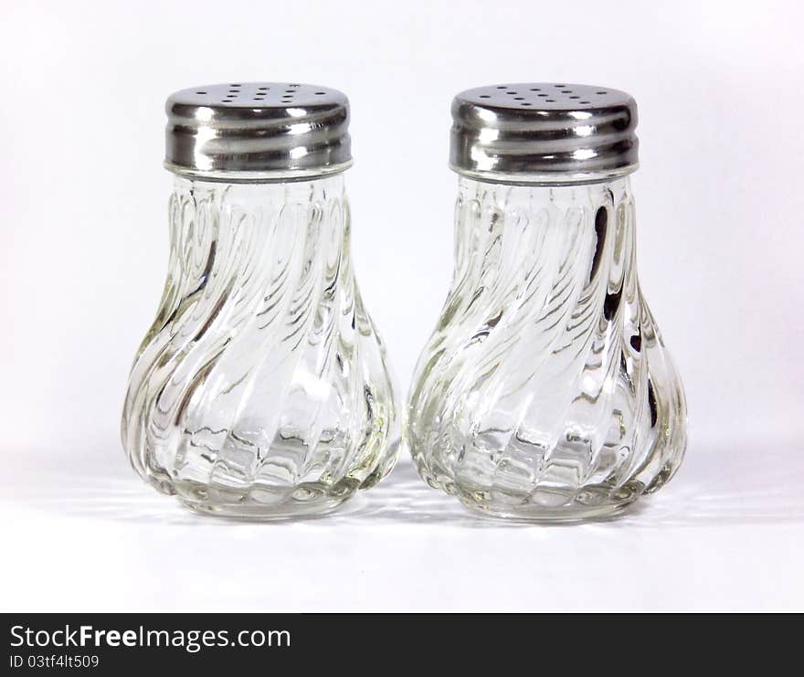 Glass empty Salt and pepper shakers on table