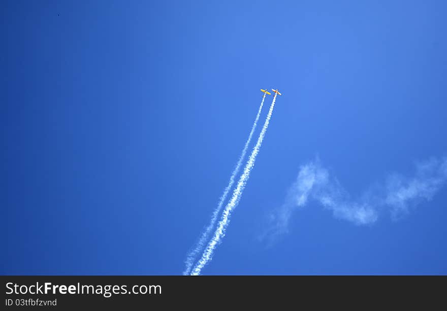 Acrobatics with two planes through the clouds. Acrobatics with two planes through the clouds