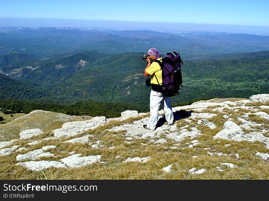 Hiker photographer in mountains