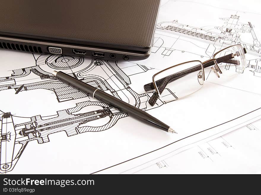 Glasses and pen lying next to a laptop. Glasses and pen lying next to a laptop