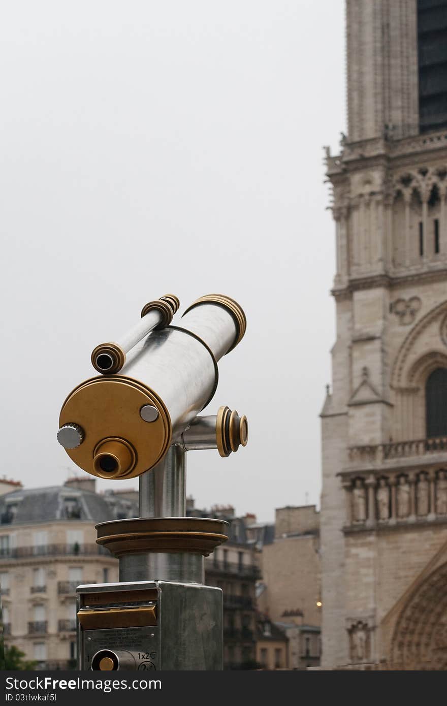 Telescope of stainless steel near Not-re-Dame Cathedral in Paris