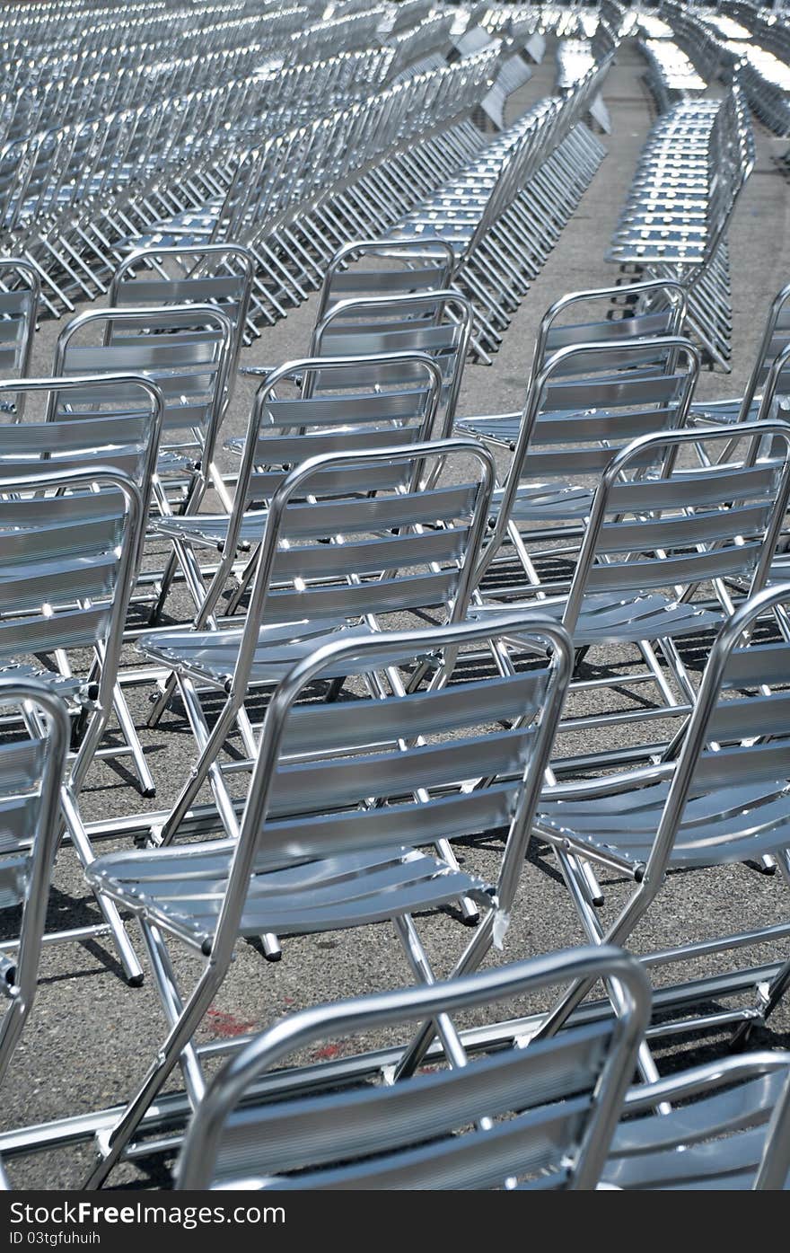 Empty metal chairs lined up for before show.