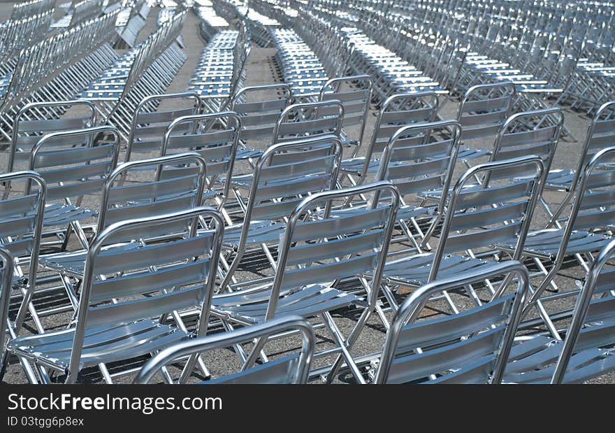 Empty metal chairs lined up for before show.