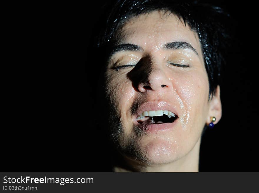 Closed portrait of a woman with drops isolated on black. Closed portrait of a woman with drops isolated on black