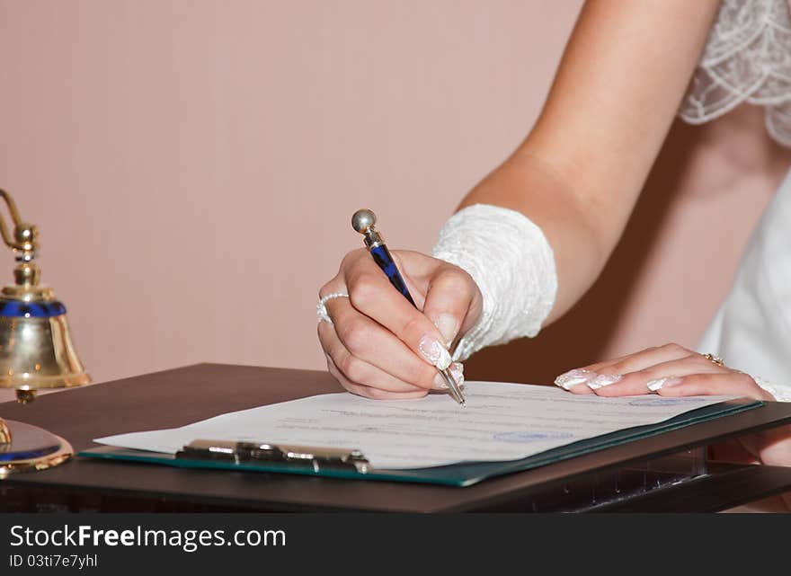 Bride signing marital agreement