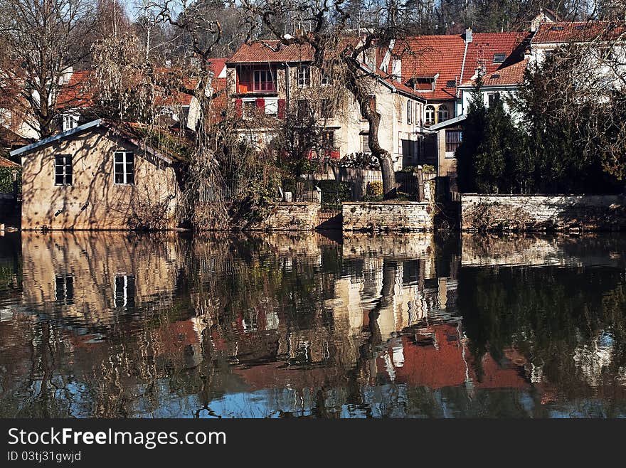 The city of Montbeliard, France. Reflection in the river.