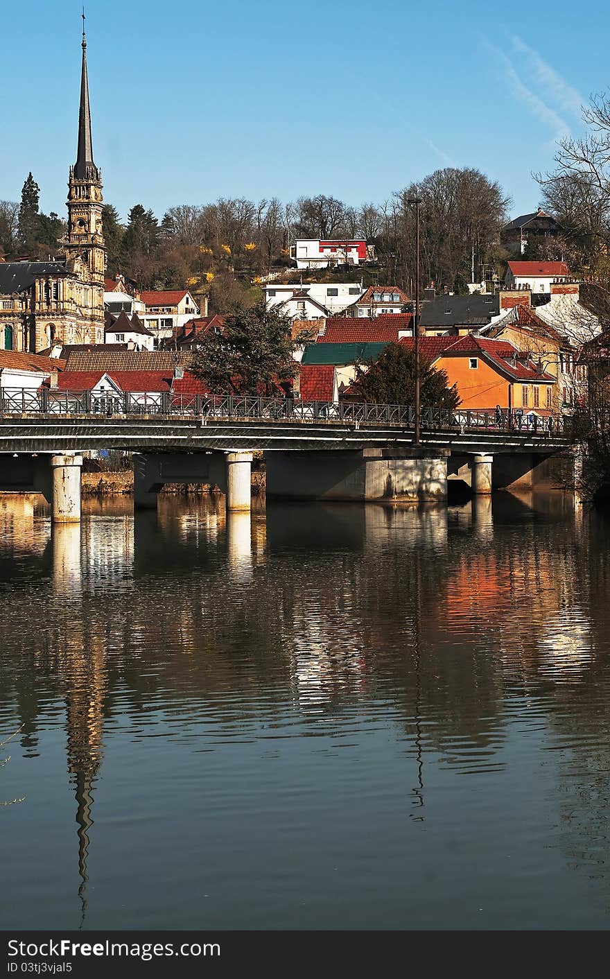 The city of Montbeliard, France. Reflection in the river by a clear and sunny morning.