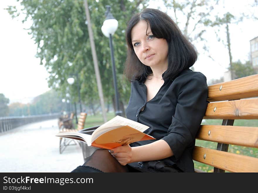 Girl reading a book on the nature