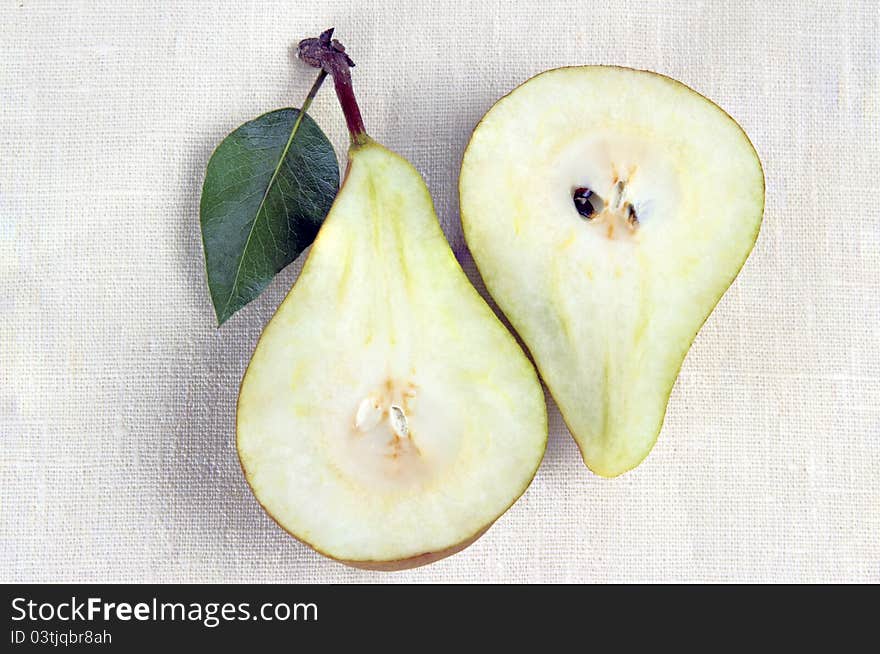 Two halves of pears on a white background