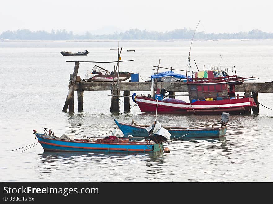 Fishing bridge and fishing boat in the sea