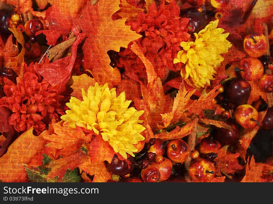 Bright autumn grunge background of mums, maple leaves, apples, cinnamon. Bright autumn grunge background of mums, maple leaves, apples, cinnamon