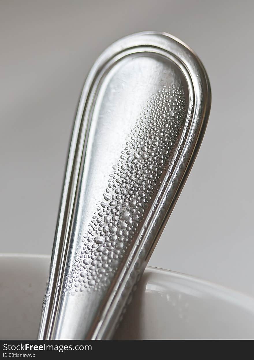 Wet spoon in cup