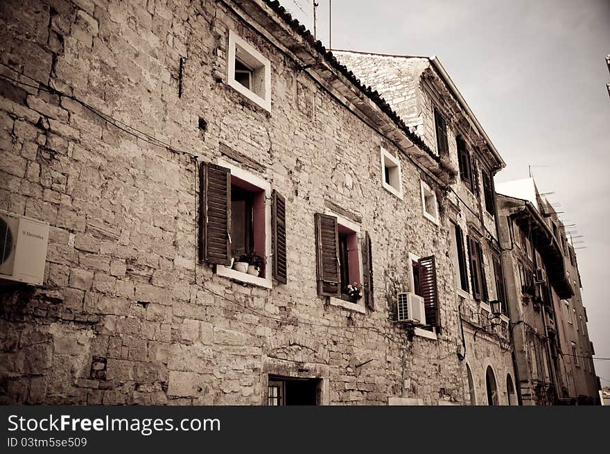 Dark image of an old stone house in Croatian town