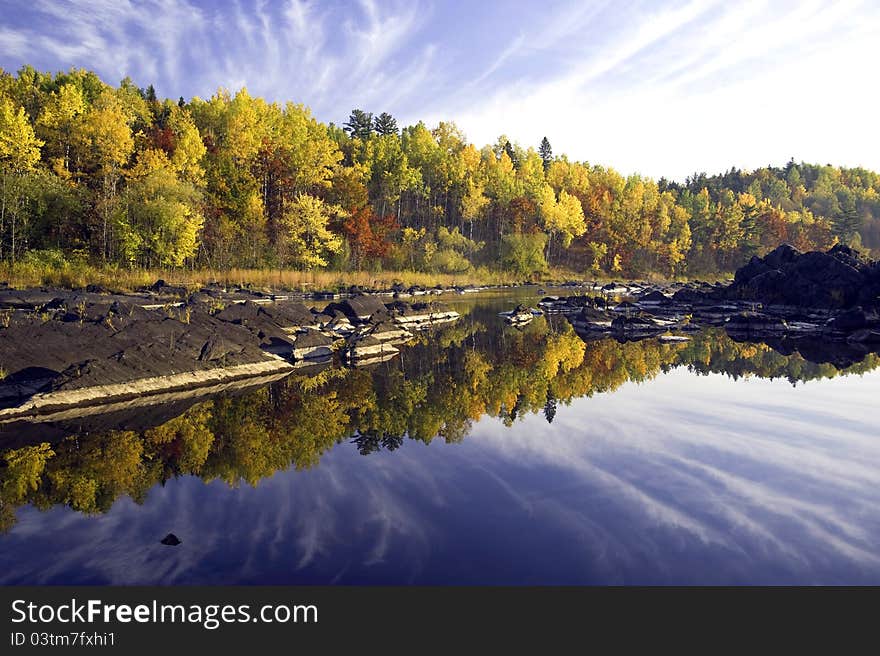 Fall colors reflecting in a calm stretch of water, Jay Cooke S P, Minnesota. Fall colors reflecting in a calm stretch of water, Jay Cooke S P, Minnesota