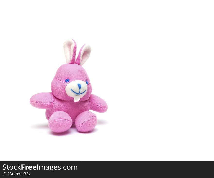 Pink toy rabbit on a white background