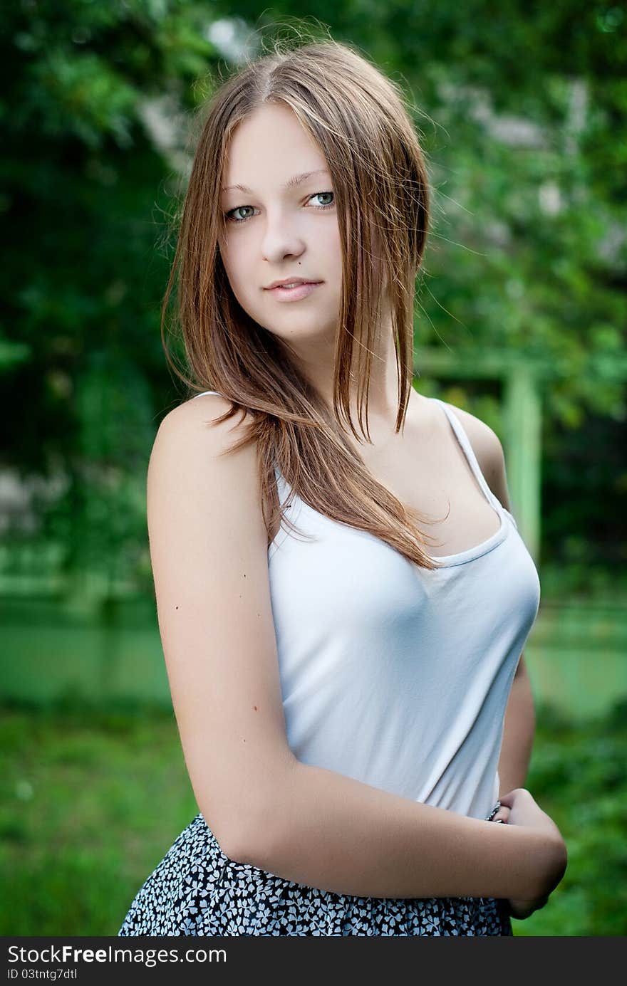 Young model portrait on green background.