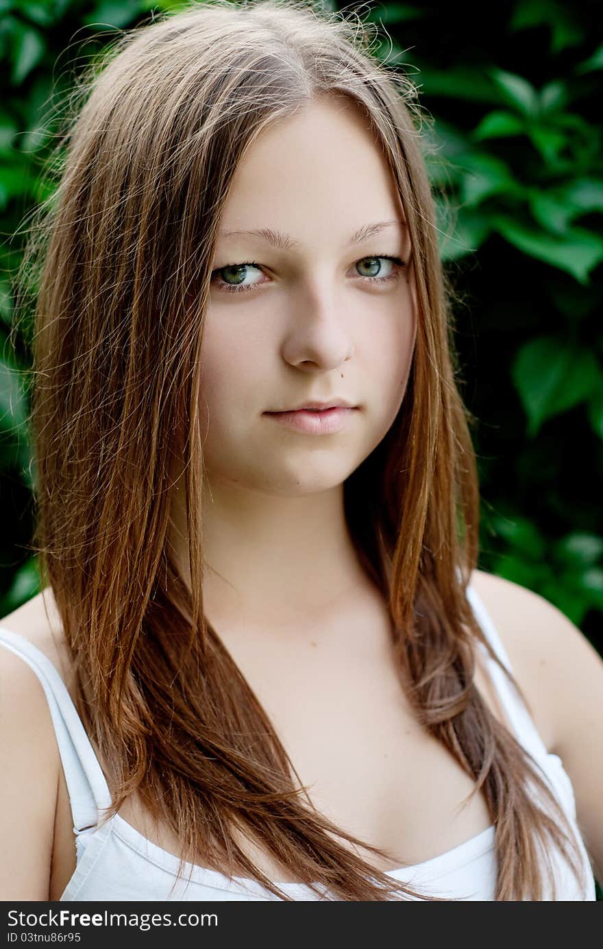 Young girl portrait on green background.