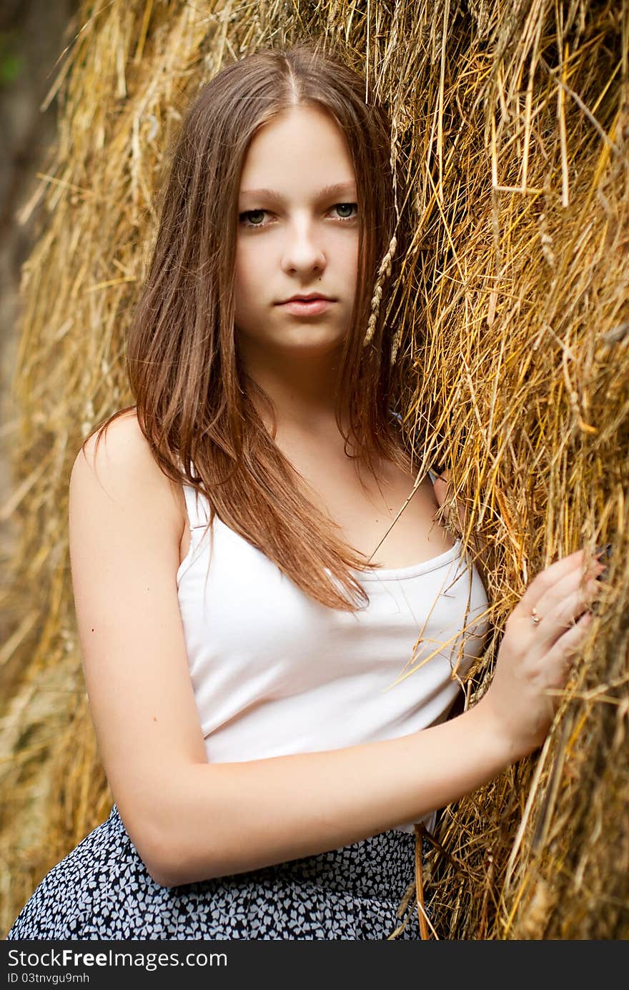 Young womans portrait with hay background.