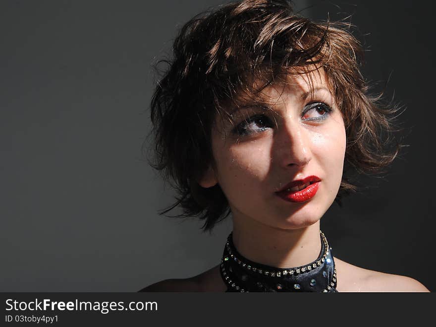 Portrait of girl with short long hair on a grey background