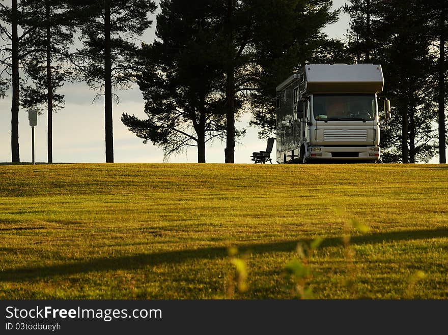 Mobile home on camping site into the sunset.