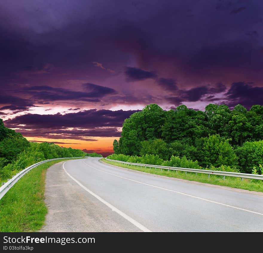 Empty road with cloudy sky and sunlight