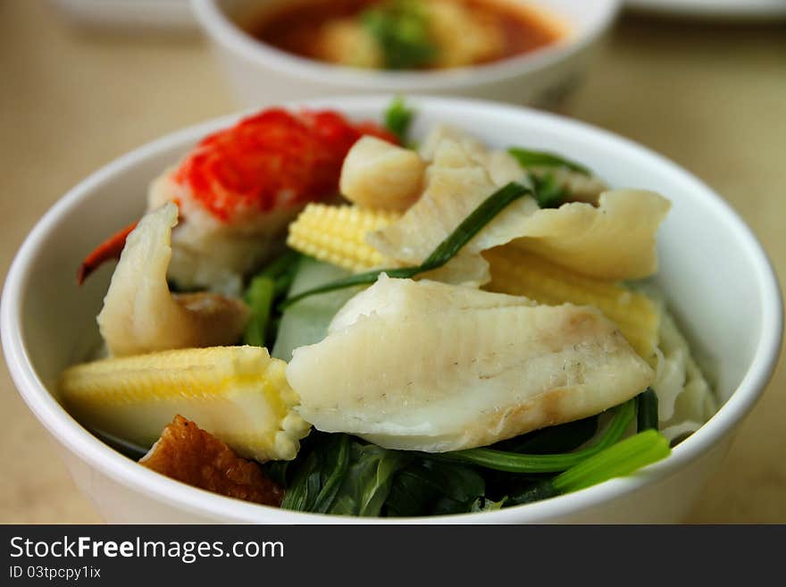 Fishes, meat, and mixed vegetables in bowl for lunch. Fishes, meat, and mixed vegetables in bowl for lunch