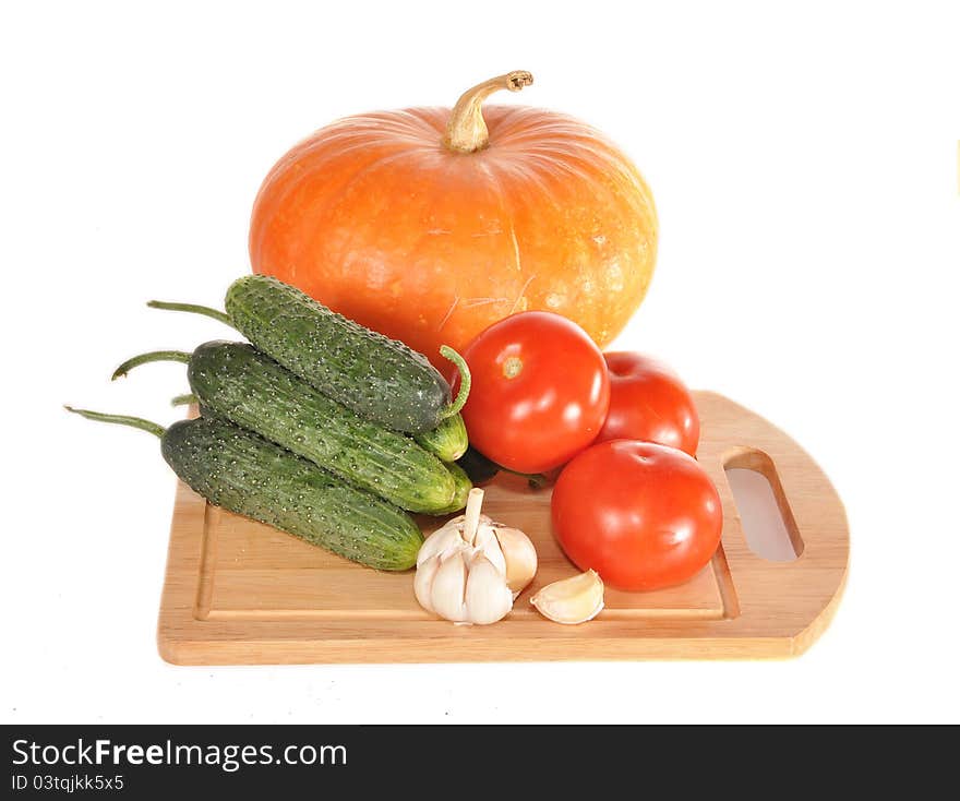 Vegetables on a board and a pumpkin