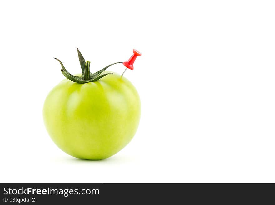 A green tomato stung by a needle. A green tomato stung by a needle