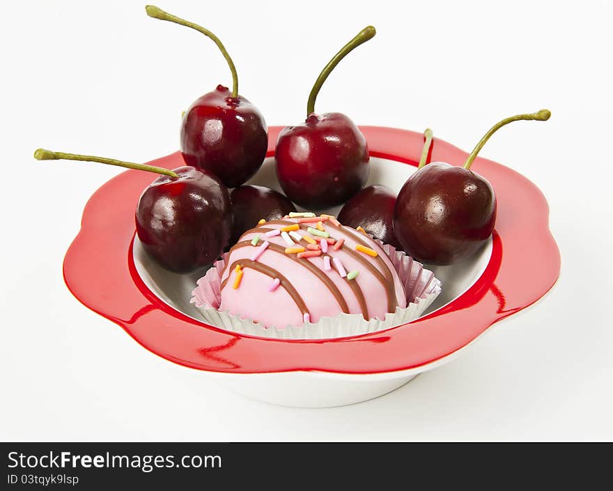 Cup of cake in red bowl with fresh Cherry isolated on white background