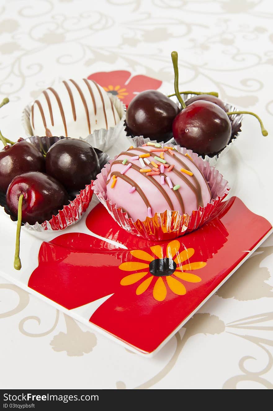 Cup of donut and Cherry in beautiful flower plate