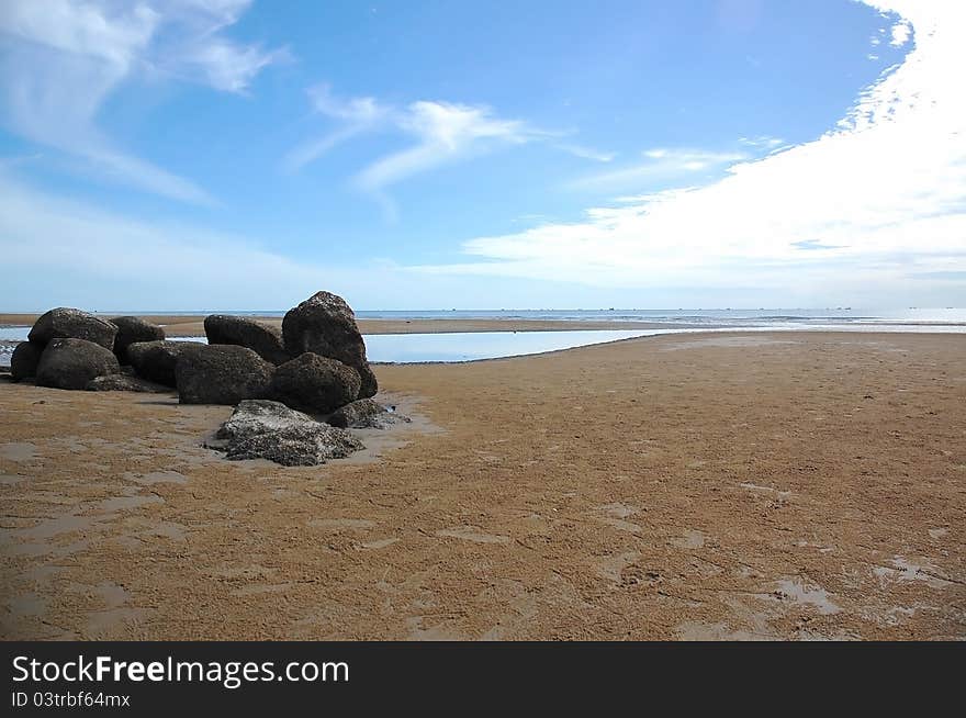 Curve of sky and seascape with black natural stone on beach at Thailand. Curve of sky and seascape with black natural stone on beach at Thailand