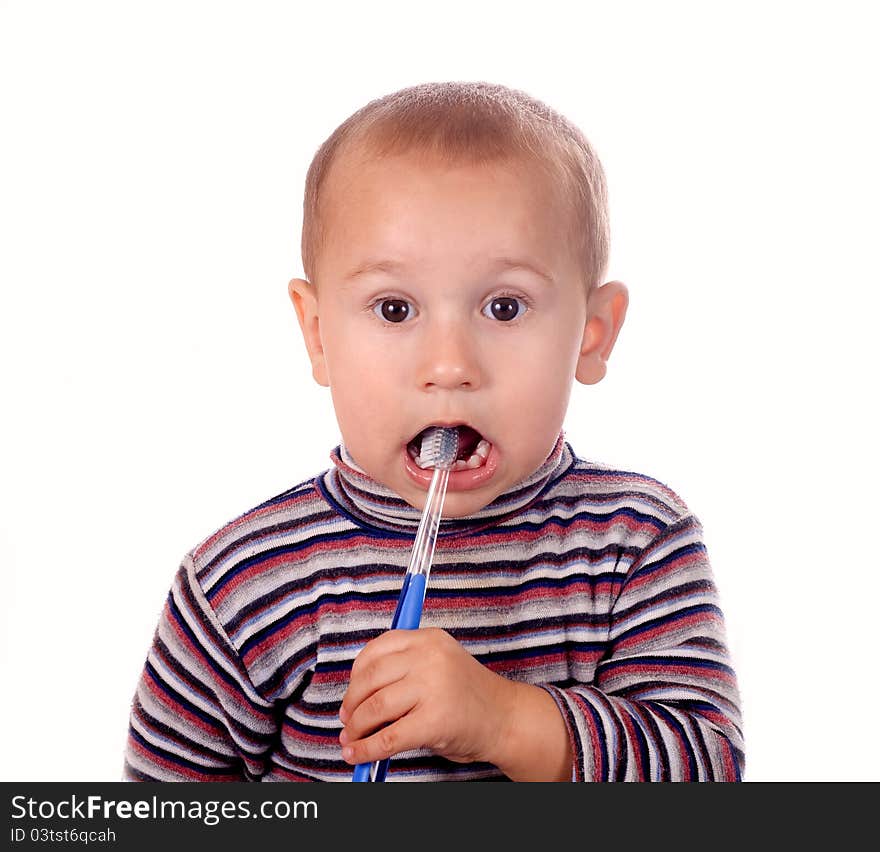 Boy brushing his teeth after bath