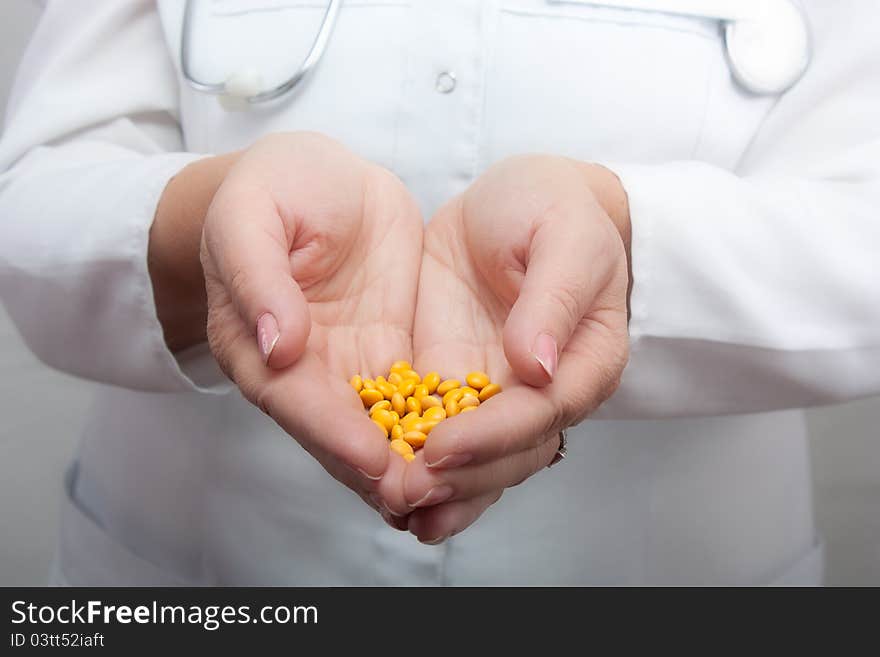 Doctor holding a handful of pills.