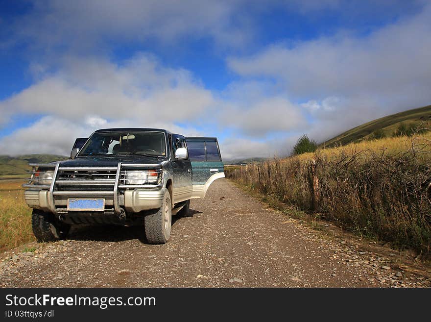 A dusty jeep is taking break from a long journey. A dusty jeep is taking break from a long journey