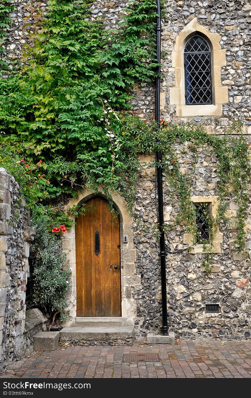 Wooden doorway in stone wall, Canterbury England. Wooden doorway in stone wall, Canterbury England