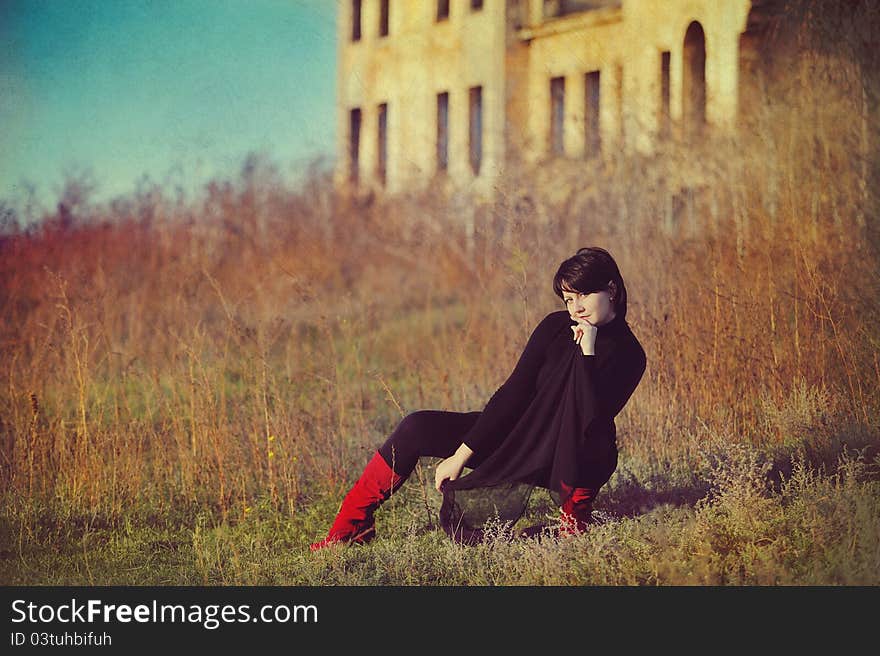 The girl against the old house. The girl against the old house