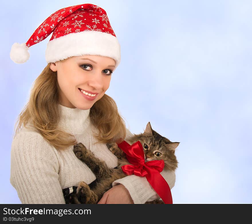 Attractive girl with a cat on a blue background