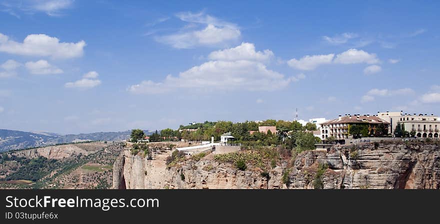Mountainside in the Spanish town of Ronda in the province of Malaga. skies are cloudy, and a landscape of shrubs in the background. Mountainside in the Spanish town of Ronda in the province of Malaga. skies are cloudy, and a landscape of shrubs in the background
