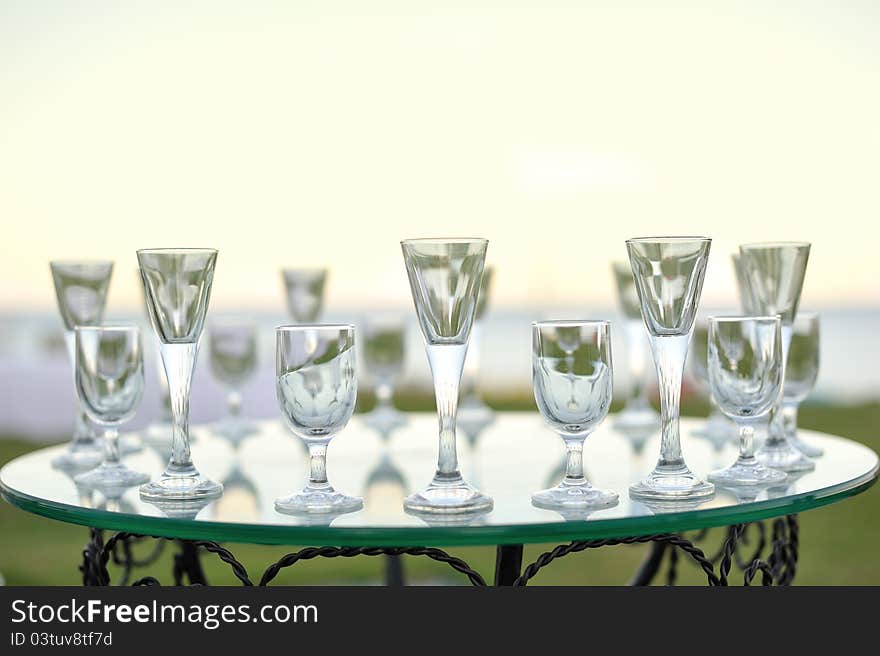 Laying of glasses on a glass table of the different sizes