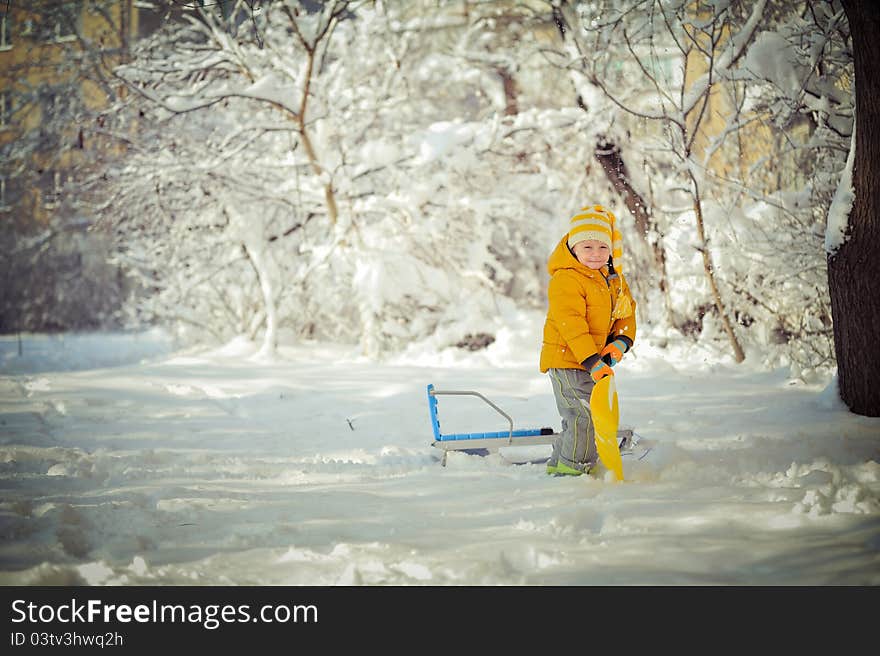 Winter walk of the child and game on snow among trees. Winter walk of the child and game on snow among trees