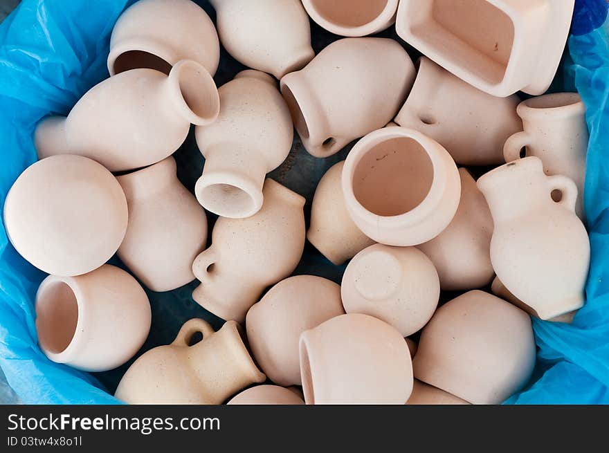 Empty jugs and pots at the blue background