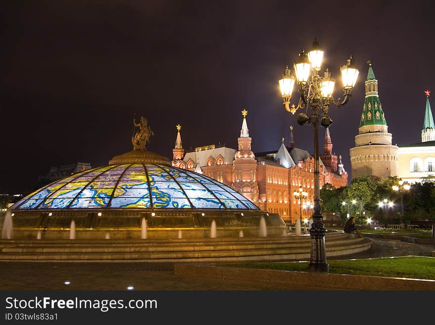 Glass cupola crowned by a statue of Saint George, holy patron of Moscow, with the View of Historical Museum and Kremlin Wall from the Manezhnaya Square. The square forms a vital part of downtown Moscow, connecting Red Square. Glass cupola crowned by a statue of Saint George, holy patron of Moscow, with the View of Historical Museum and Kremlin Wall from the Manezhnaya Square. The square forms a vital part of downtown Moscow, connecting Red Square.