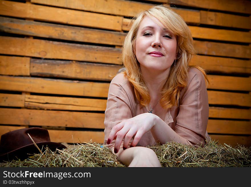 Pretty cowboy girl in farm interior. Pretty cowboy girl in farm interior