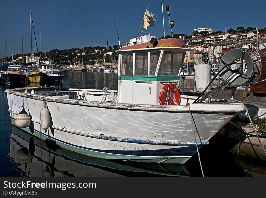 Fishing boat at its moorings in the port of Cassis, south-east of France. Fishing boat at its moorings in the port of Cassis, south-east of France.